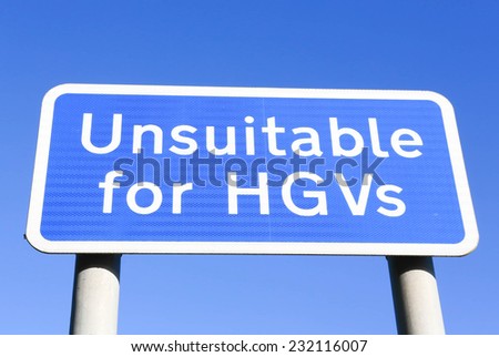 Unsuitable for  HGV s road sign against a clear blue sky background.