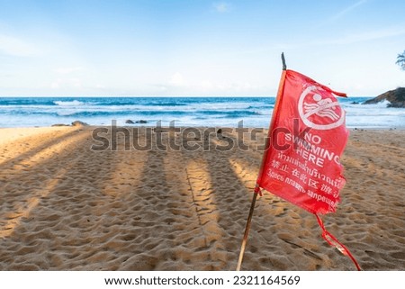 Close focus on red flag for warning not to swim due to dangerous beach area.