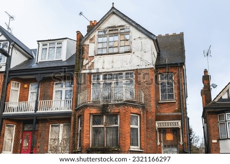 An abandoned terrace house, boarded up and neglected, around Hornsey in London Royalty-Free Stock Photo #2321166297
