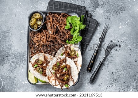 Cooking of Mexican lamb Barbacoa Tacos with Cilantro and Onion. Gray background. Top view.
