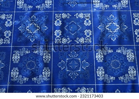 This is a patterned blue floor mat made of plastic