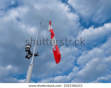direction wind indicator is an aviation instrument that provides aircraft pilots with information on wind direction. calm sky