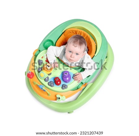 Cute little boy in baby walker on white background, above view