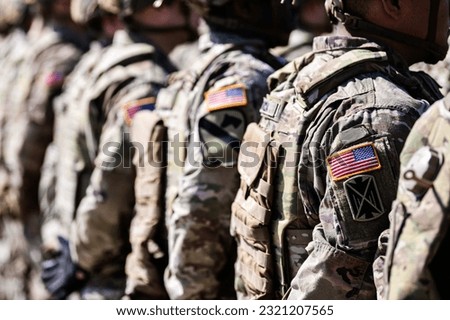 United States Army. Close up photo with the flag of America on soldiers shoulder uniform, US army concept image. Royalty-Free Stock Photo #2321207565
