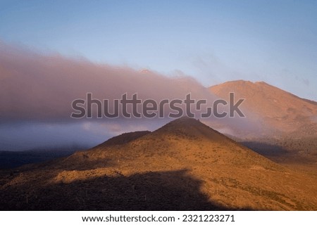 Mountainous landscape with low clouds.