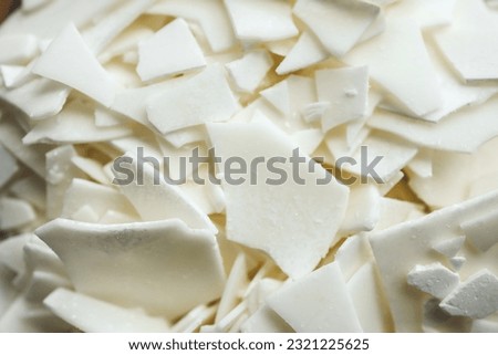 Close up of white soy wax flakes for candle making. Light texture of soy wax flakes. Ingredient for homemade candles. Ecological lifestyle. Royalty-Free Stock Photo #2321225625