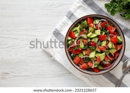 Homemade Mediterranean Cucumber Tomato Salad in a Bowl, top view. Flat lay, overhead, from above. 