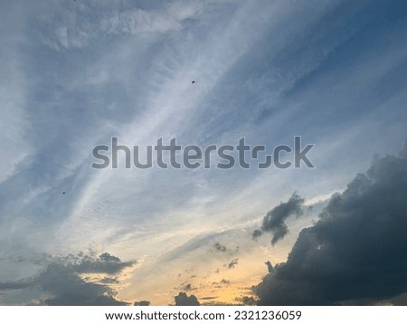Large gray cumulonimbus clouds Imagination like a dragon chasing a wolf appear in the sky along with the cirrus clouds at Bangkok, Thailand.no focus Royalty-Free Stock Photo #2321236059