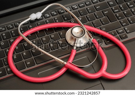 Online medicine, telemedicine red medical stethoscope lying on a laptop Royalty-Free Stock Photo #2321242857