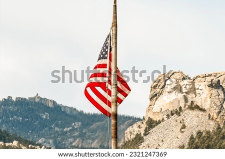 The American flag on the pole with mountain background