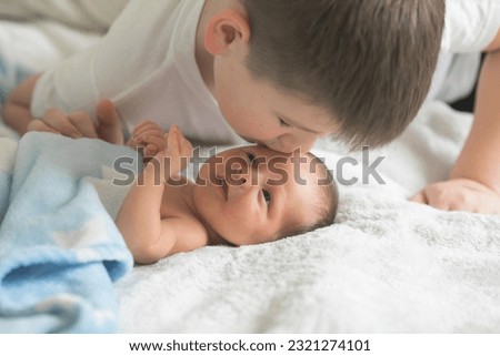 Big brother with his little newborn brother. love family concept Royalty-Free Stock Photo #2321274101