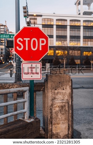Stop sign on Alaskan Way in Seattle with "Yield to Pedestrians" sign at Pier 70 on the waterfront