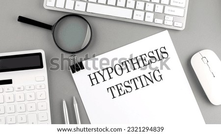 Hypothesis testing written on paper with office tools and keyboard on grey background Royalty-Free Stock Photo #2321294839