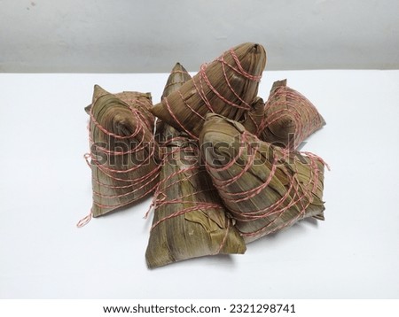 Cantonese Zongzi, sticky rice dumplings in Cantonese-style, wrapped in bamboo leaves and tied with two-colour cotton strings