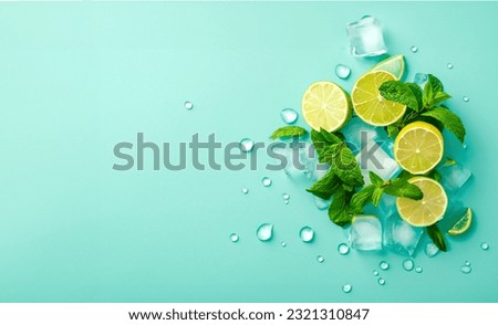 Photo top view photo of mint leaves whole and sliced limes halves of lemon ice cubes and water drops on isolated pastel