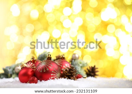 Christmas balls on snow on bright background