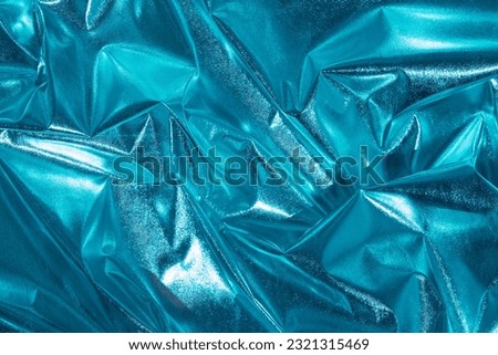 Abstract blue crumpled foil background. Minimal party concept.