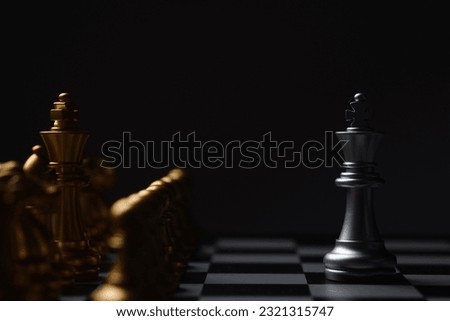 Chess Single king stand alone against many enemies as a symbol of difficult unequal fight or struggle of minorities confidence concept. Royalty-Free Stock Photo #2321315747