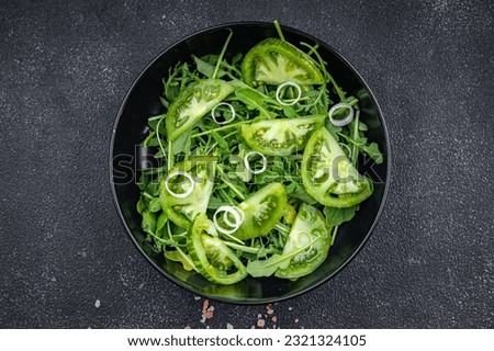 green tomato salad healthy meal food snack on the table copy space food background rustic top view keto or paleo diet veggie vegan or vegetarian food Royalty-Free Stock Photo #2321324105