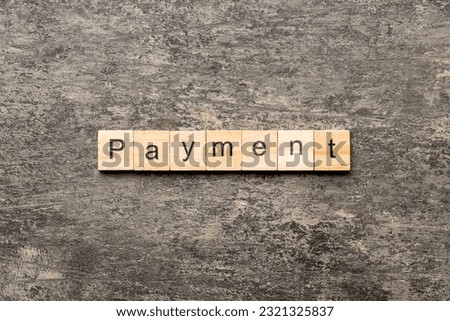 Payment word written on wood block. Payment text on cement table for your desing, concept.