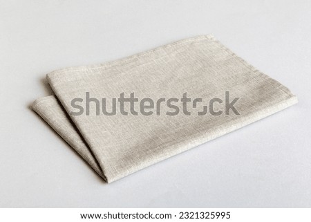 top view with gray kitchen napkin isolated on table background. Folded cloth for mockup with copy space, Flat lay. Minimal style. Royalty-Free Stock Photo #2321325995