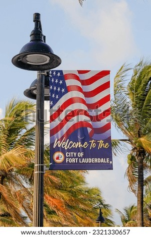 The US flag on Fort Lauderdale's beach picturesque palm trees in the background, Florida, USA