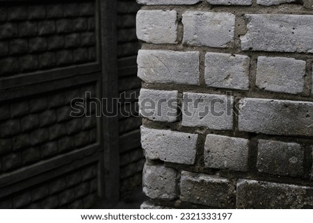 Photo of white brickwork and concrete fence. Construction and repair. City buildings. At home.