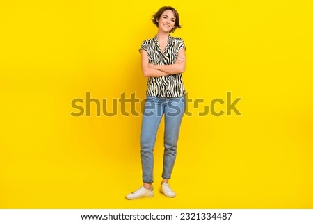 Full length photo of business lady hold folded arms toothy smiling wear print blouse jeans shoes isolated yellow color background