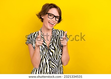 Photo of positive lovely funky girl with bob hairdo dressed zebra print shirt eyewear directing at you isolated on yellow color background