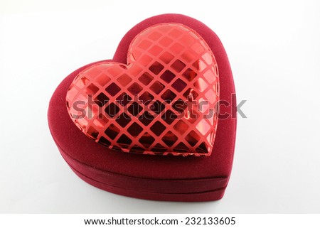 Red velvet heart shaped box isolated on white.
