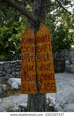 A vertical shot of a wooden sidewalk sign in the mountain Biokovo in Croatia