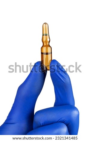 Doctor's hand in blue gloves holding ampoule isolated on white background.