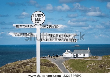 A post with various signs in the area of the Land's End, a headland and tourist complex in western Cornwall Royalty-Free Stock Photo #2321349593