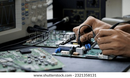 Electronics technician, electronic engineering electronic repair,electronics measuring and testing, repair and maintenance concepts. Royalty-Free Stock Photo #2321358131