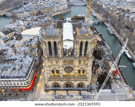 Aerial drone view of Notre-Dame Cathedral during reparation works in Paris, France. The Restoration of the cathedral Notre Dame in Paris is due to the fact that a massive fire ravaged its wooden roof  Royalty-Free Stock Photo #2321365593