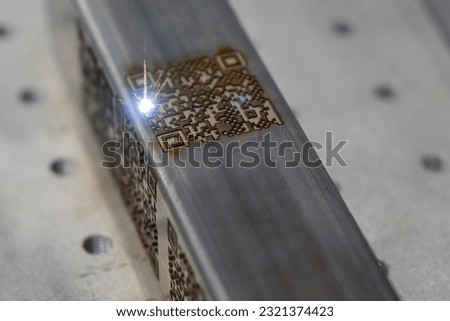 The barcode on square metal  pipe from etching machine. The laser etching machine. Royalty-Free Stock Photo #2321374423