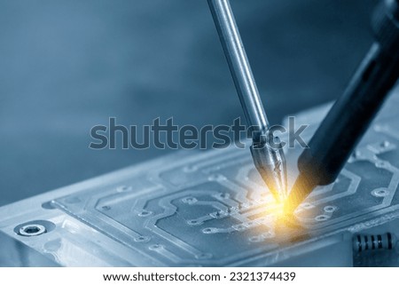 The automatic soldering machine operation with PCB board. The hi-technology electronics industry assembly process by robotic system. Royalty-Free Stock Photo #2321374439