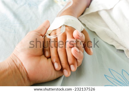  mother holding child's hand who fever patients have IV tube.