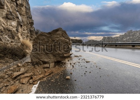 Rainy road rockslide blocking traffic lane on Santa Susana Pass Road in the Chatsworth area of Los Angeles, California.   Royalty-Free Stock Photo #2321376779