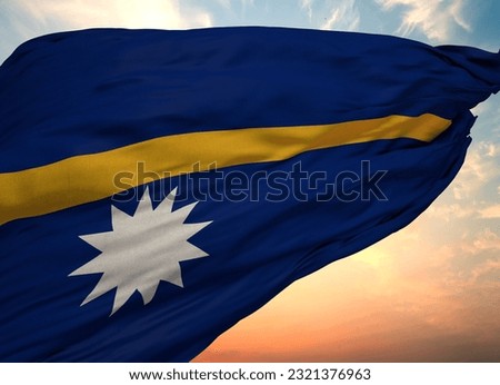 An illustration of a waving flag of Nauru with golden sunset sky on the background