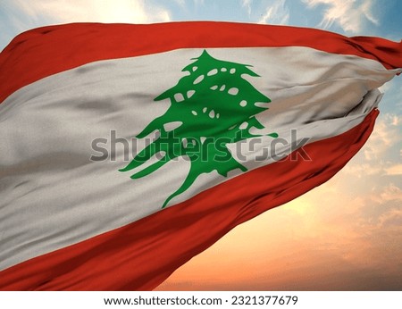 A lebanese flag waving in the wind with the blue sky in the background