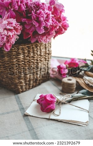 Craft letters and pink peony, spring composition.