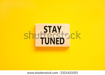 Stay tuned symbol. Concept words Stay tuned on wooden blocks on a beautiful yellow table yellow background. Business, support, motivation, psychological and stay tuned concept. Copy space. Royalty-Free Stock Photo #2321421055