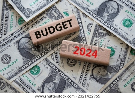 Budget 2024 symbol. Wooden blocks with words Budget 2024. Beautiful dollar background. Business and Budget 2024 concept. Copy space.