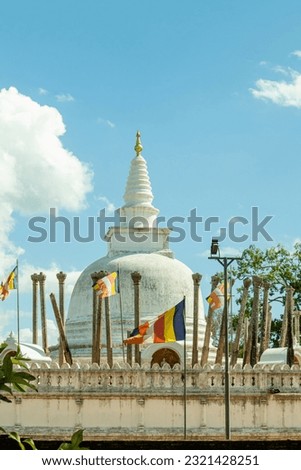 thuparamaya White stupa with flags on blue sky background, Anuradhapuraya, Sri lanka.