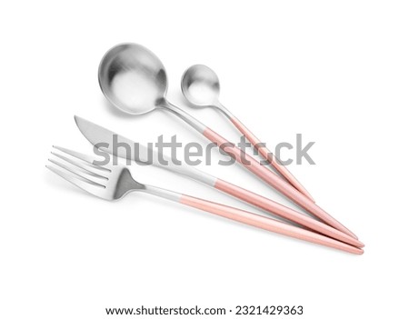 Stainless steel set of cutlery with pink handles on white background Royalty-Free Stock Photo #2321429363