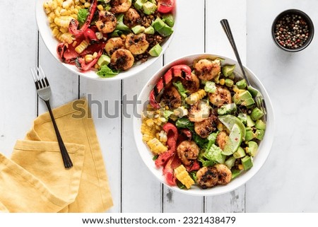 Cajun prawn bowls loaded with fresh vegetables, avocados and rice. Royalty-Free Stock Photo #2321438479