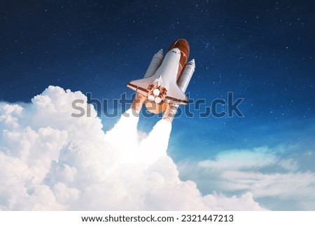 New Rocket flies to another planet. Spaceship takes off into the starry sky. Rocket starts into space. Concept. Spaceship shuttle lift off through the clouds.  Royalty-Free Stock Photo #2321447213