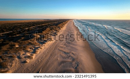 Aerial view of coastline and sand dunes of Ocracoke Island at sunrise, North Carolina, USA. Royalty-Free Stock Photo #2321491395