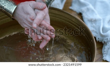 Pontius Pilate washing his hands in a bronze basin filled with water. Detail Royalty-Free Stock Photo #2321491599